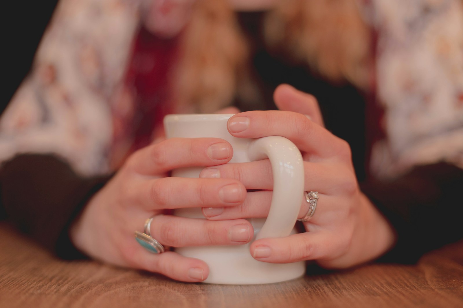 person holding white ceramic mug